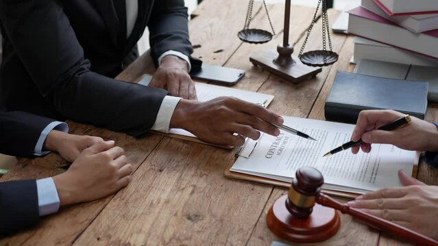Consultation and meeting of professional male lawyers and businesswomen working and discussing contracts at law firm. concept of law judge with scales of justice.	
