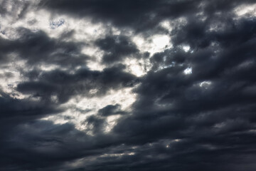 Obraz premium The sky is filled with dark clouds. Cloudscape has been developing in gorgeous form. 