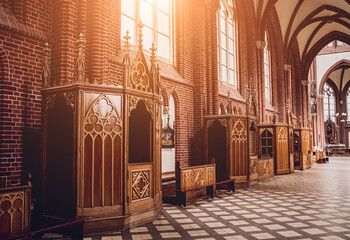 Row of confessionals booth of old european catholic church. - obrazy, fototapety, plakaty
