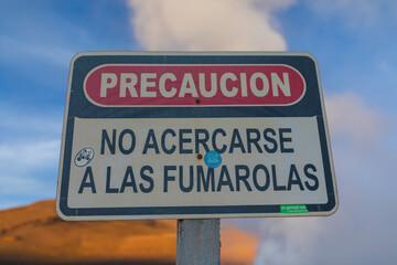 Schild das auf Gefahren hinweist vor einem Geysir in der Salar de uyuni in Bolivien