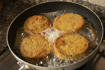 frying in pan of eggplants in carriage