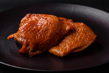 Delicious fried or smoked chicken thighs grilled with spices and herbs