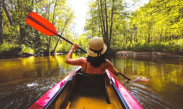 Back view Kayaking couple in river. POV of woman and man kayaking in beautiful landscape. Aquatic sports during fall autumn concept.Beautiful calm relaxing warm scenic trees autumn