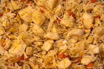 Tasty pilaf with chicken as background.