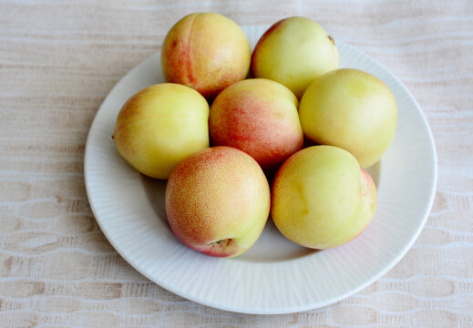 yellow plums on the plate isolated, close up 