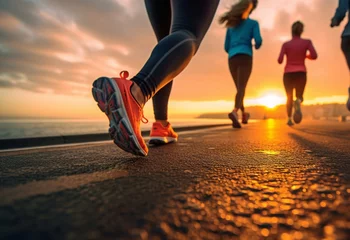 Poster Laufgruppe am Ufer: Beine von Sportlern im Fokus bei morgendlichem Lauf am Strand © PhotoArtBC