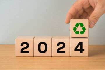 year 2024. Sustainable development concept, Date on wooden blocks and added block with ecological...