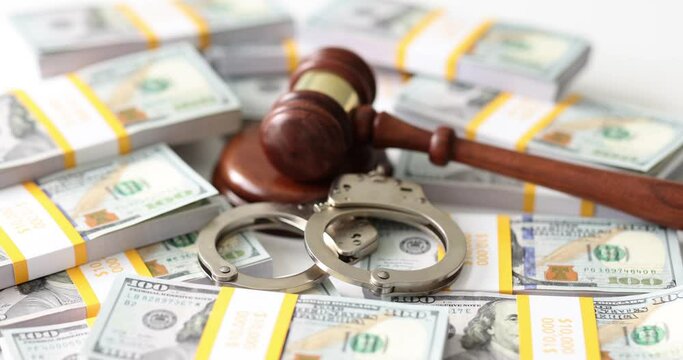 Judge gavel with handcuffs on background of stacks of dollar bills. Judge gavel, dollar bills handcuffs arrest and bail