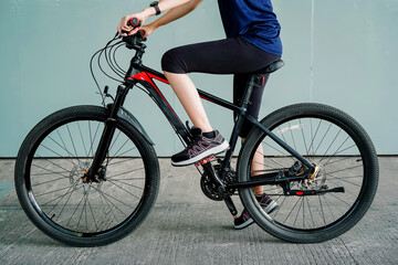 Photo of a girl doing bicycle exercise, and wearing sports shoes   