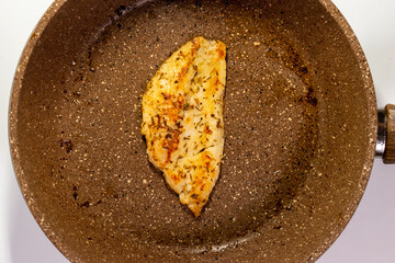 Seasoned Raw dory on a Frying Pan