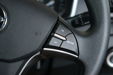 Selective focus picture car dial button at steering wheel.