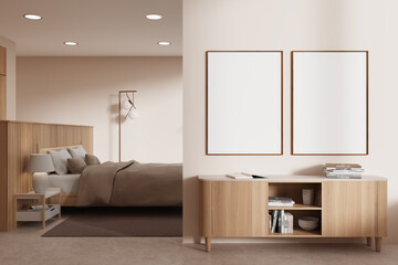 Beige bedroom interior with dresser and posters