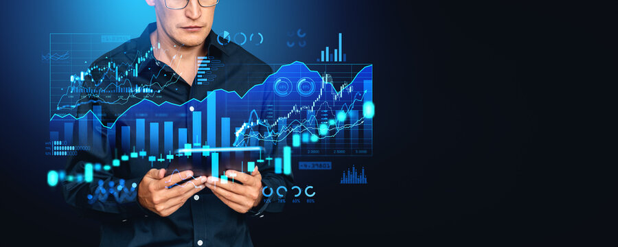 Businessman working with tablet in hands, forex diagrams and financial dashboard