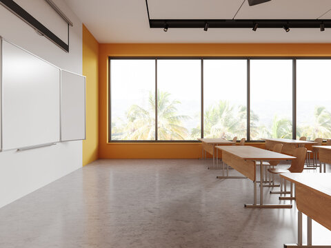 Stylish classroom interior with table in row and chalkboard mockup, window