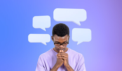 Pensive African man college student with speech bubbles