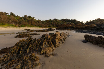 Rock formation around the sandy area of the beach.