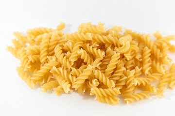 Raw auger pasta on the white background