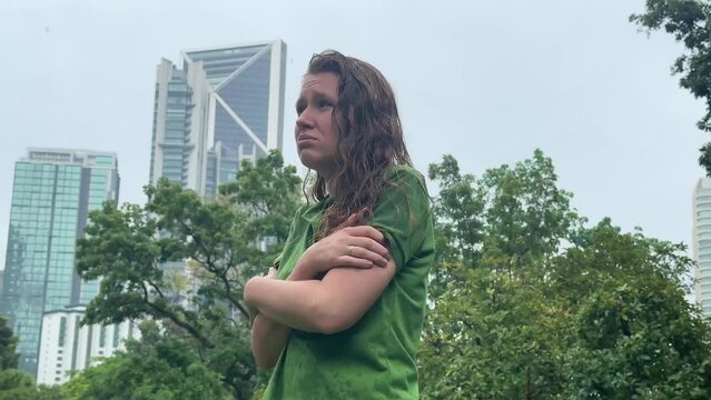 Sad woman under summer rain.emotional girl wet in the rain without umbrella.woman walk in the rain.young attractive woman is wet in the rain