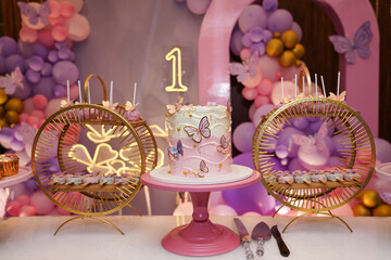 Butterfly themed birthday decor with a beautiful gourmet cake for a party