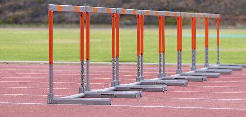 Eight track hurdles on a track in each lane