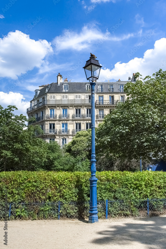 Wall mural paris, ancient building, typical facade in a public park, with a lamppost