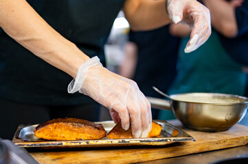 Chef hand cooking Roasted salmon fish steak on restaurant kitchen