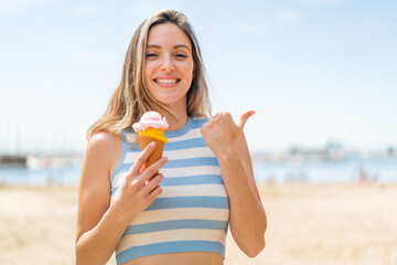 Young pretty woman with a cornet ice cream at outdoors pointing to the side to present a product