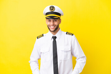 Airplane caucasian pilot isolated on yellow background laughing