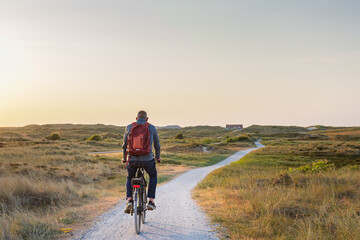 Cyling during dusk to the beach of Formerum at Wadden island Terschelling Friesland province in The Netherlands
