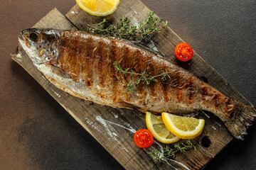 Roasted trout with lemon. Grilled trout, organic healthy products. Detox and clean diet concept