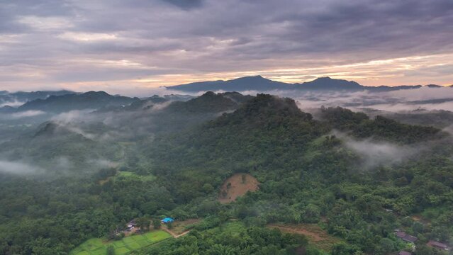 4K motion time lapse video aerial view morning scenery Mist flowing over the high mountains The movement of fog and clouds, Pang Puey, Mae Moh, Lampang, Thailand
