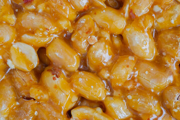 Top view: Gozinaki - caramelized nuts fried in honey - orange granola peanut bar - close up, macro. Traditional Georgian cuisine, oriental sweet, gastronomy and food concept