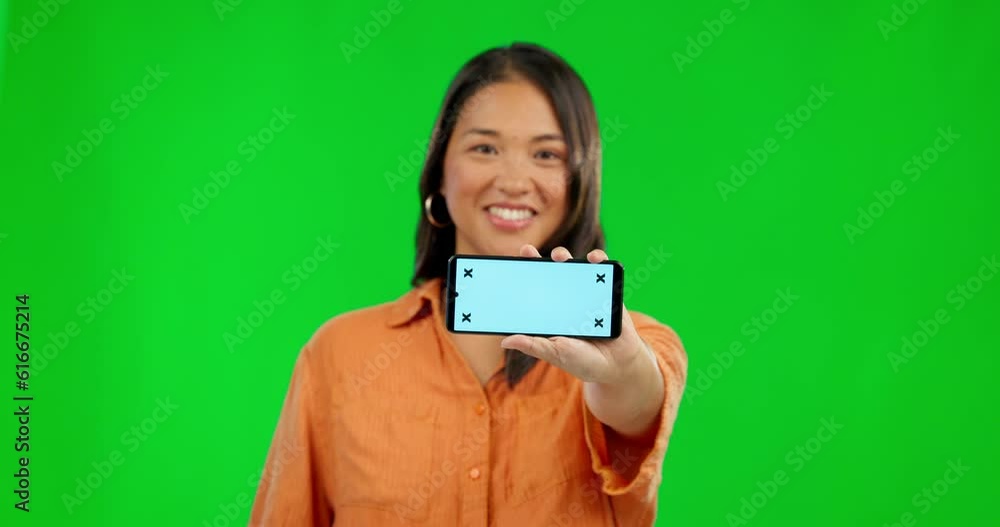 Wall mural Happy woman, phone and mockup on green screen for advertising against a studio background. Portrait of female person showing mobile smartphone app with mock up display, tracking markers and chromakey