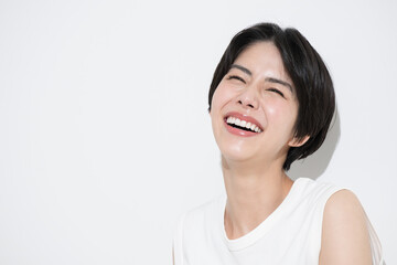 Beauty image of a close-up of an Asian woman's face with a tan and UV rays, easy to use for summer images Bright copy space available