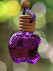 Purple air freshener with creamy blur on background