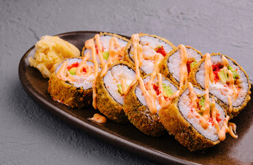 set of tempura fried sushi rolls on plate
