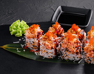 Japanese sushi volcano roll with eel on top and sesame inside