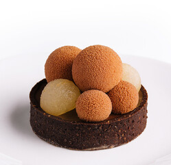 chocolate mini tart decorated with chocolate balls
