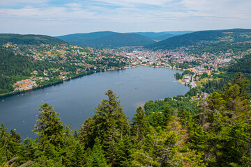 Fototapeta na wymiar aerial view to the village of Gerardmer with lake and sailing boats