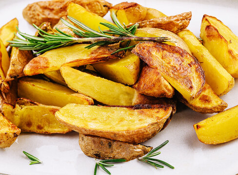 Fried Potatoes With Rosemary On Plate