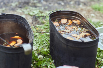 Bowler cooking food bonfire cauldron camp fire, pot. Hiking pot in the bonfire. Traveling in the...