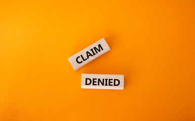 Claim denied symbol. Wooden blocks with words Claim denied. Beautiful orange background. Business and Claim denied concept. Copy space.