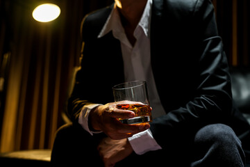 businessmen holding a glass of whiskey