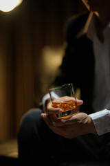 businessmen holding a glass of whiskey