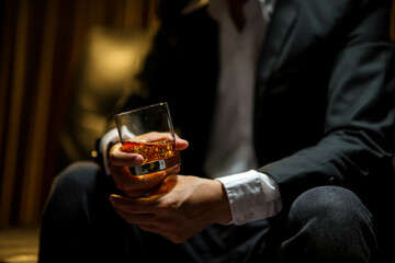 businessmen holding a glass of whiskey