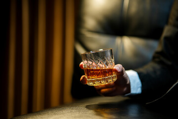 businessmen holding a glass of whiskey