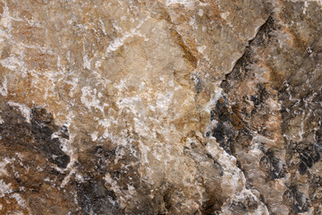 Background from a photo of a chipped multicolored natural stone with white veins and cracks