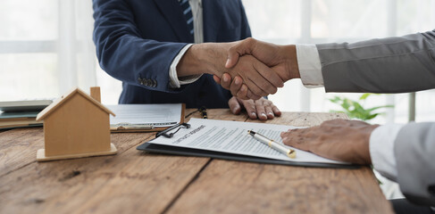 Handshake of real estate brokers with customers or investors, mortgage loan agreements Make a lease-purchase-sell house and home insurance mortgage loan concept.