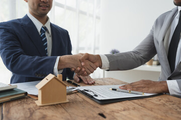 Handshake of real estate brokers with customers or investors, mortgage loan agreements Make a lease-purchase-sell house and home insurance mortgage loan concept.