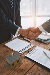 Handshake of real estate brokers with customers or investors, mortgage loan agreements Make a lease-purchase-sell house and home insurance mortgage loan concept.